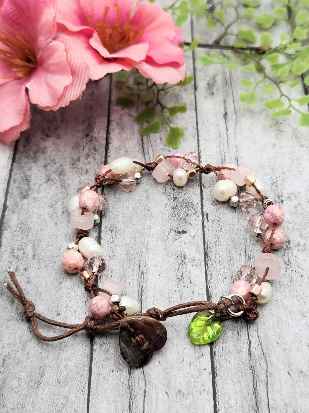 This is a beautiful cluster style bracelet that captures the pink, white, and brown of Cherry Blossoms on a branch.