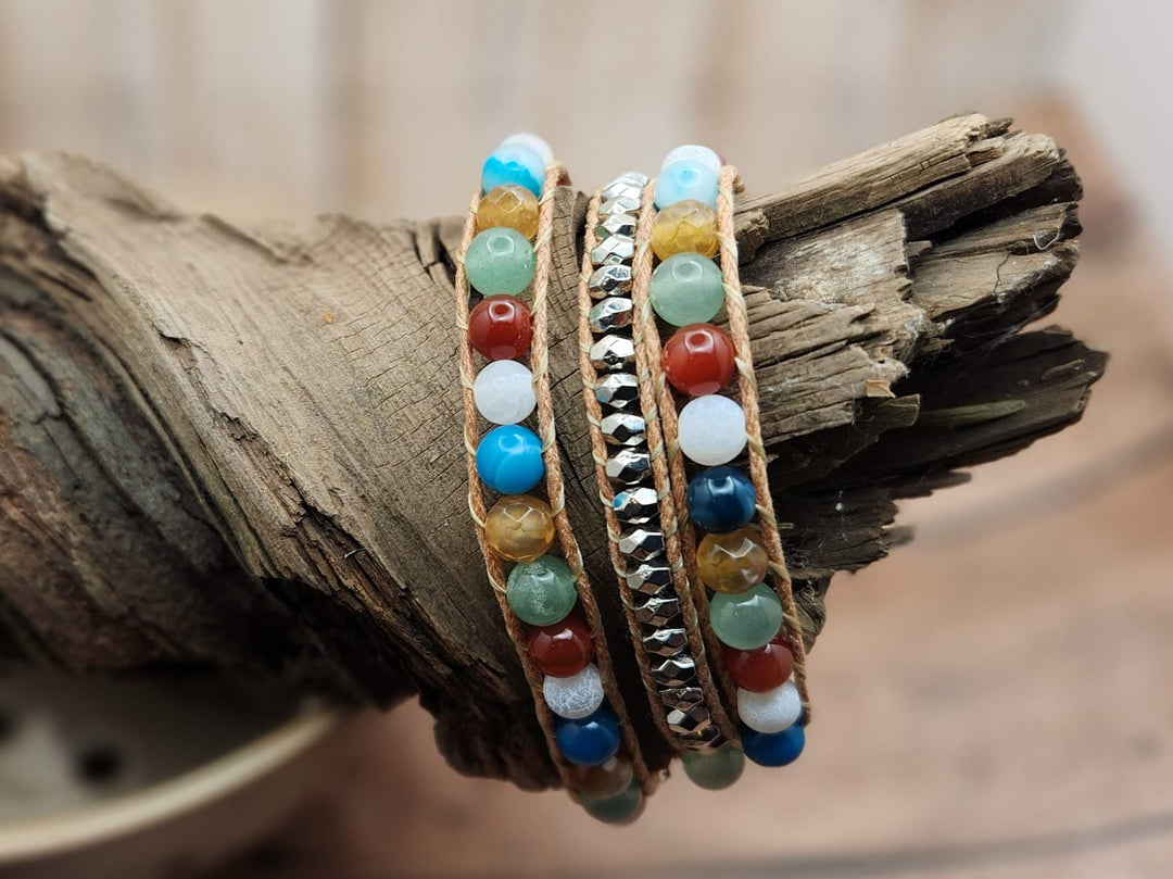 This is a unique 3 wrap style bracelet that uses shades of orange, white, blue, soft yellow and soft green to mimic the colors of a butterfly.