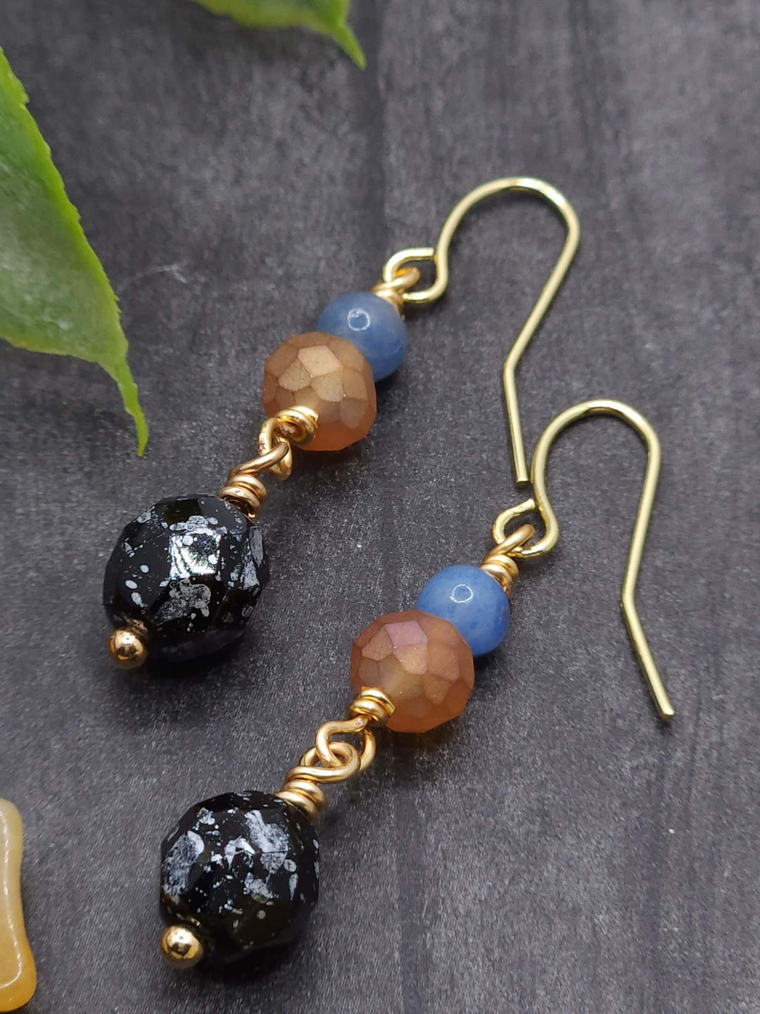  This close-up photo of the American Kestrel earrings highlights the textures of the beads used in the earrings. 