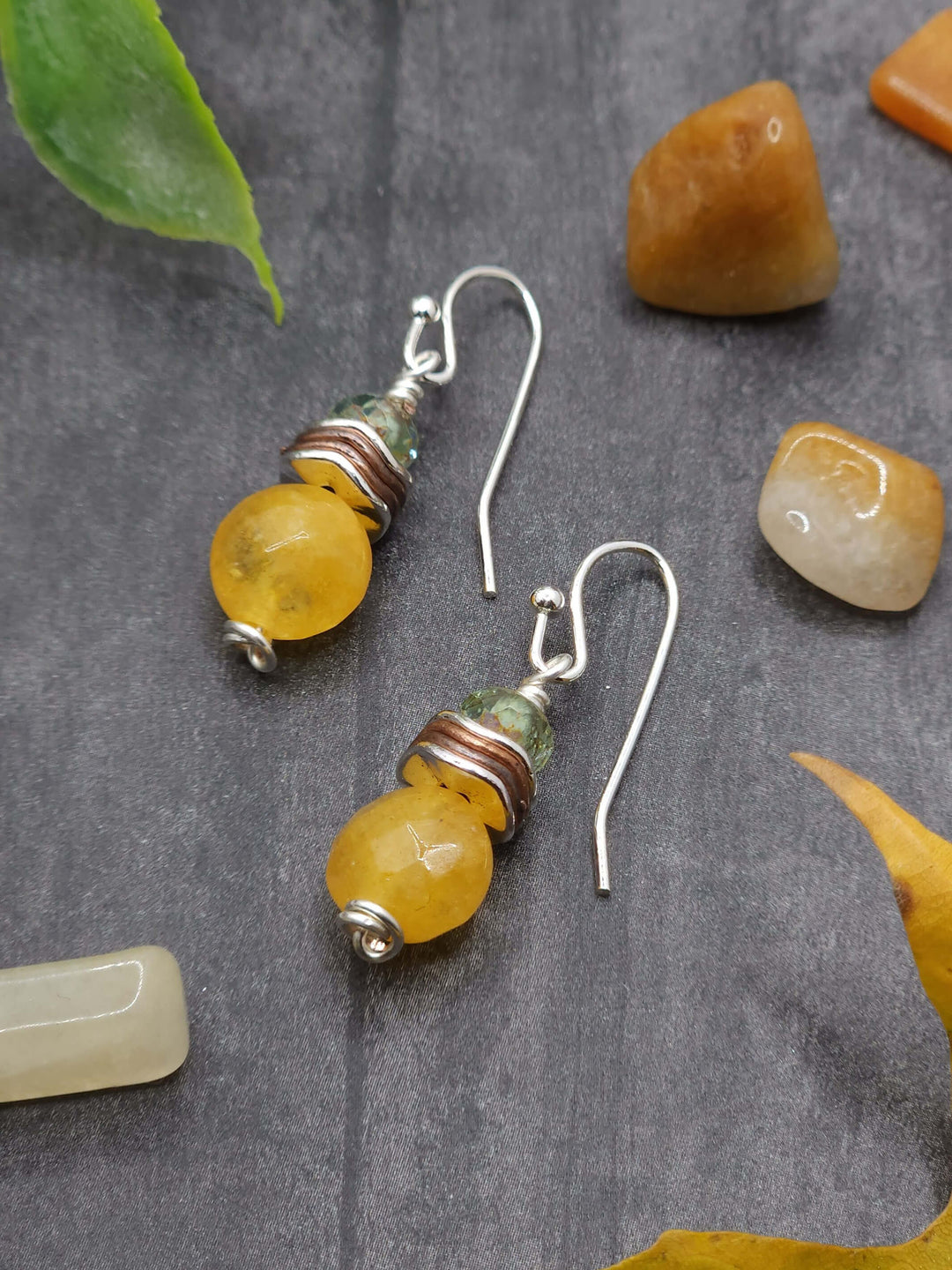 This photo of Barn Owl Earrings highlights the soft shimmer of the faceted citrine coin bead alongside the silver and copper wavy spacers, and the Czech Glass rondelles. 