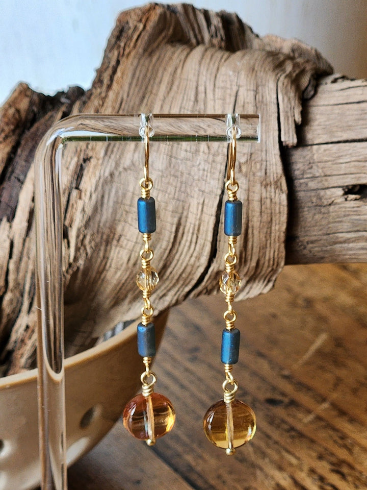 This photo highlights the beautiful soft yellow and blue colors of the earrings against a wood background. 