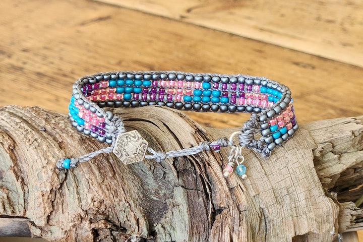 This photo shows the adjustable 3 button closer and charms of the Starfish Loom Bracelet. 